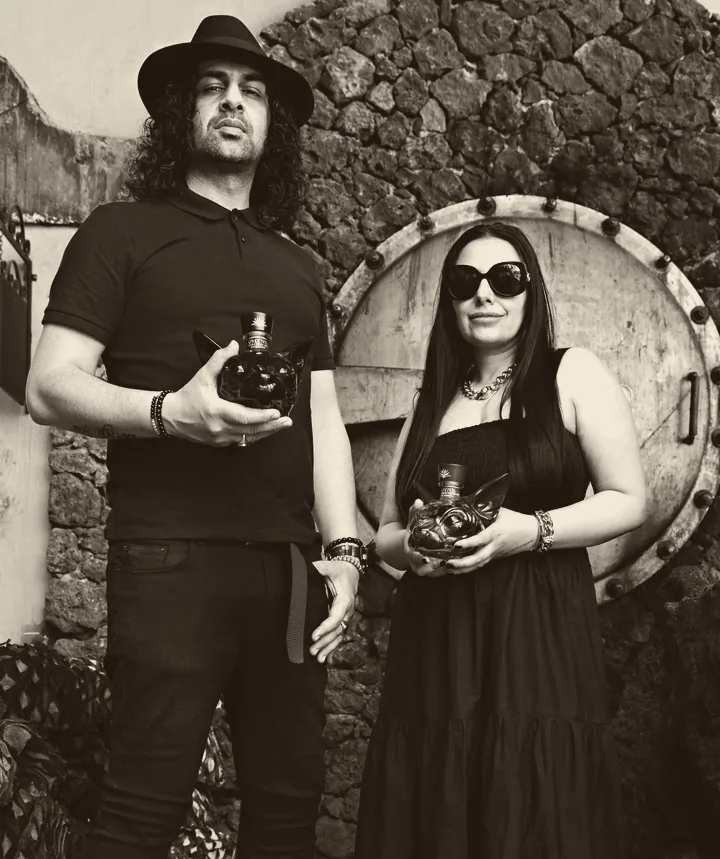 Sukhvinder and Imran Javeed, both in black, each holding a SPHYNX decanter