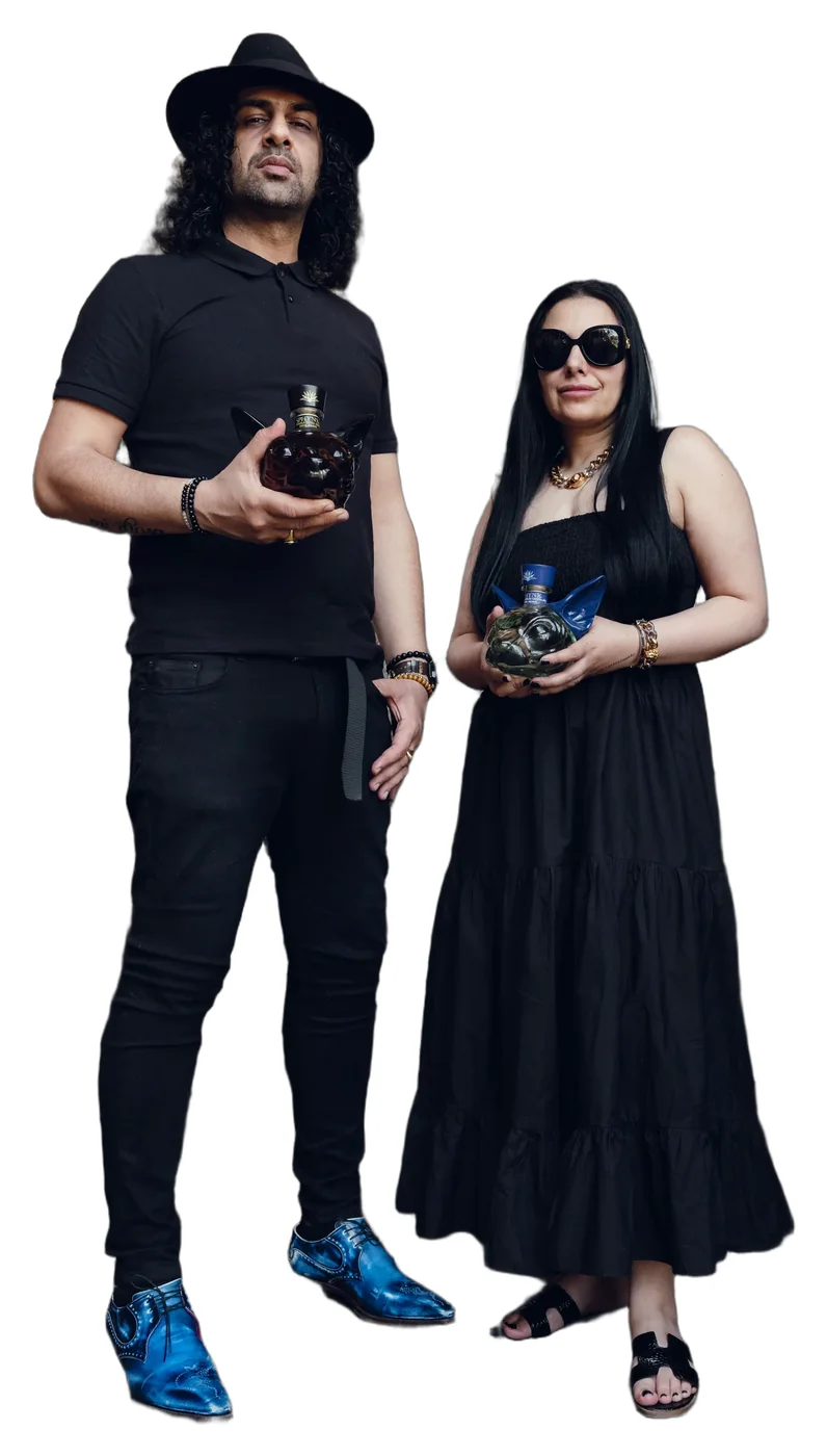 Sukhvinder and Imran Javeed, both in black, each holding a SPHYNX decanter