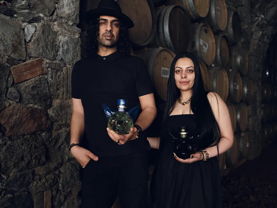 Sukhvinder and Imran Javeed with SPHYNX decanters in a barrel room